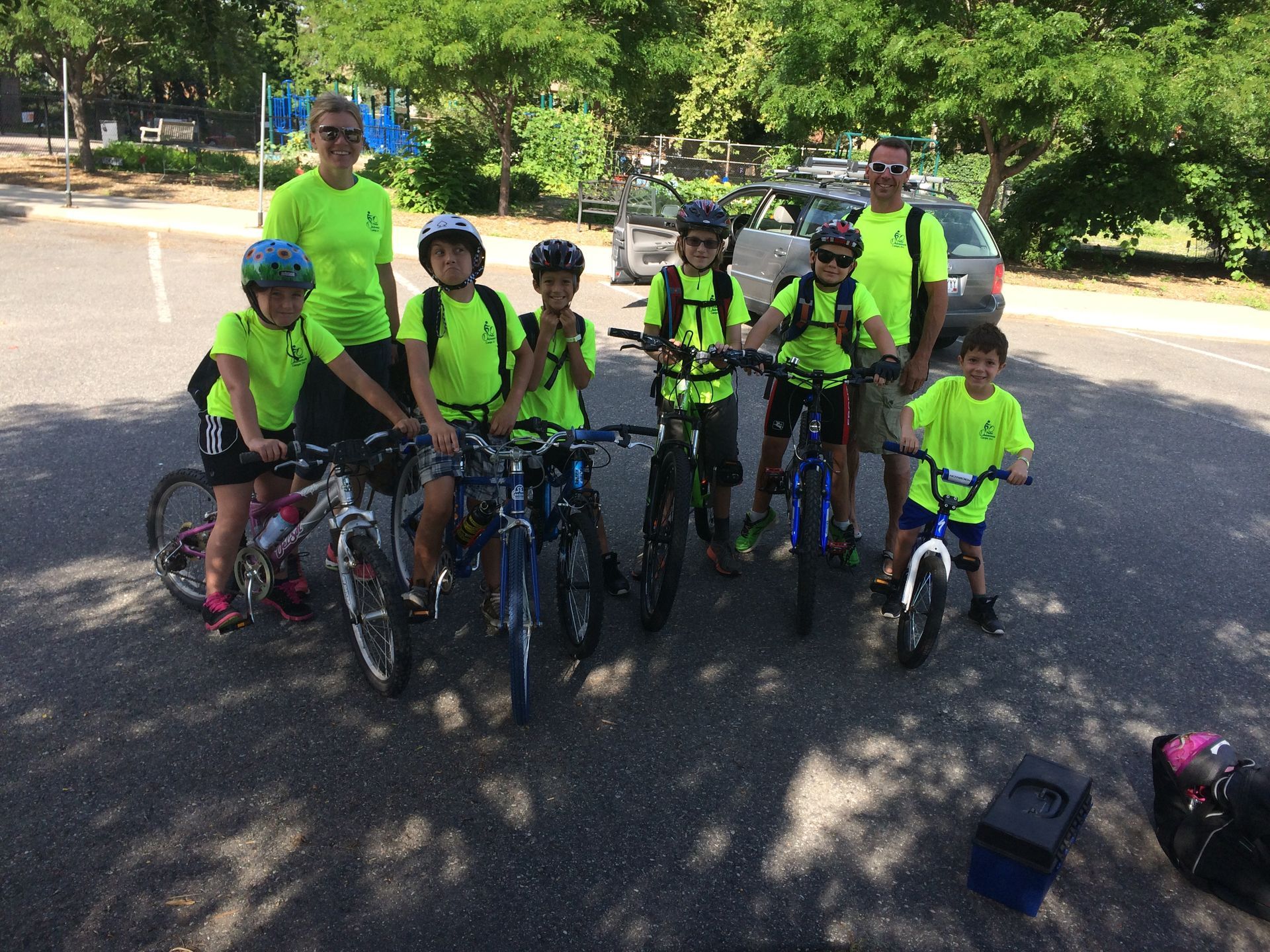 A group of children are posing for a picture with their bikes