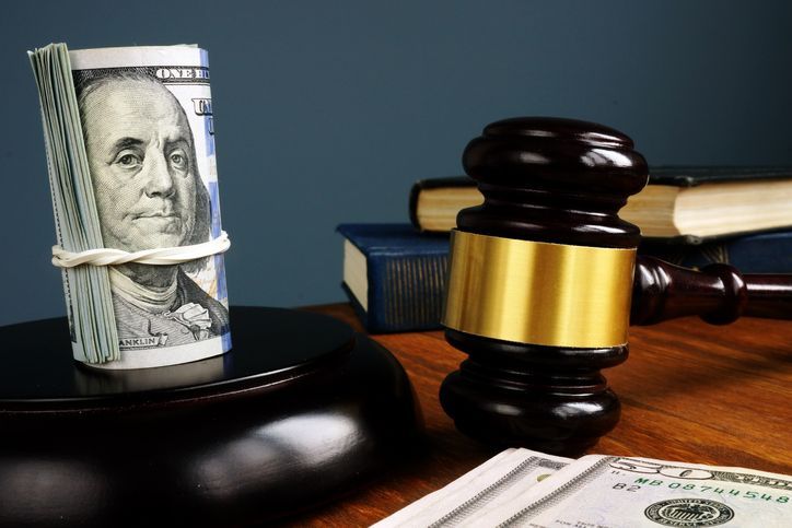 Money and gavel as symbols of bail bonds.