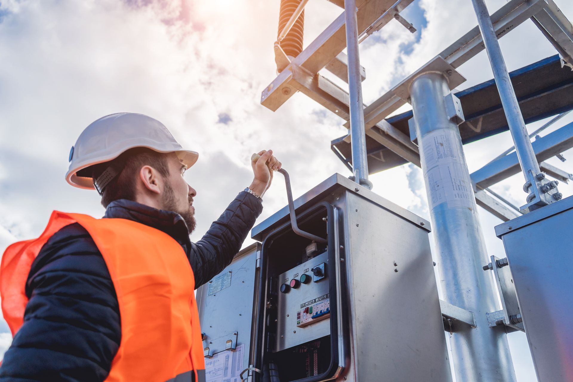 Generator installation technician inspecting electrical control panel. Generator installation technician inspecting electrical control panel.