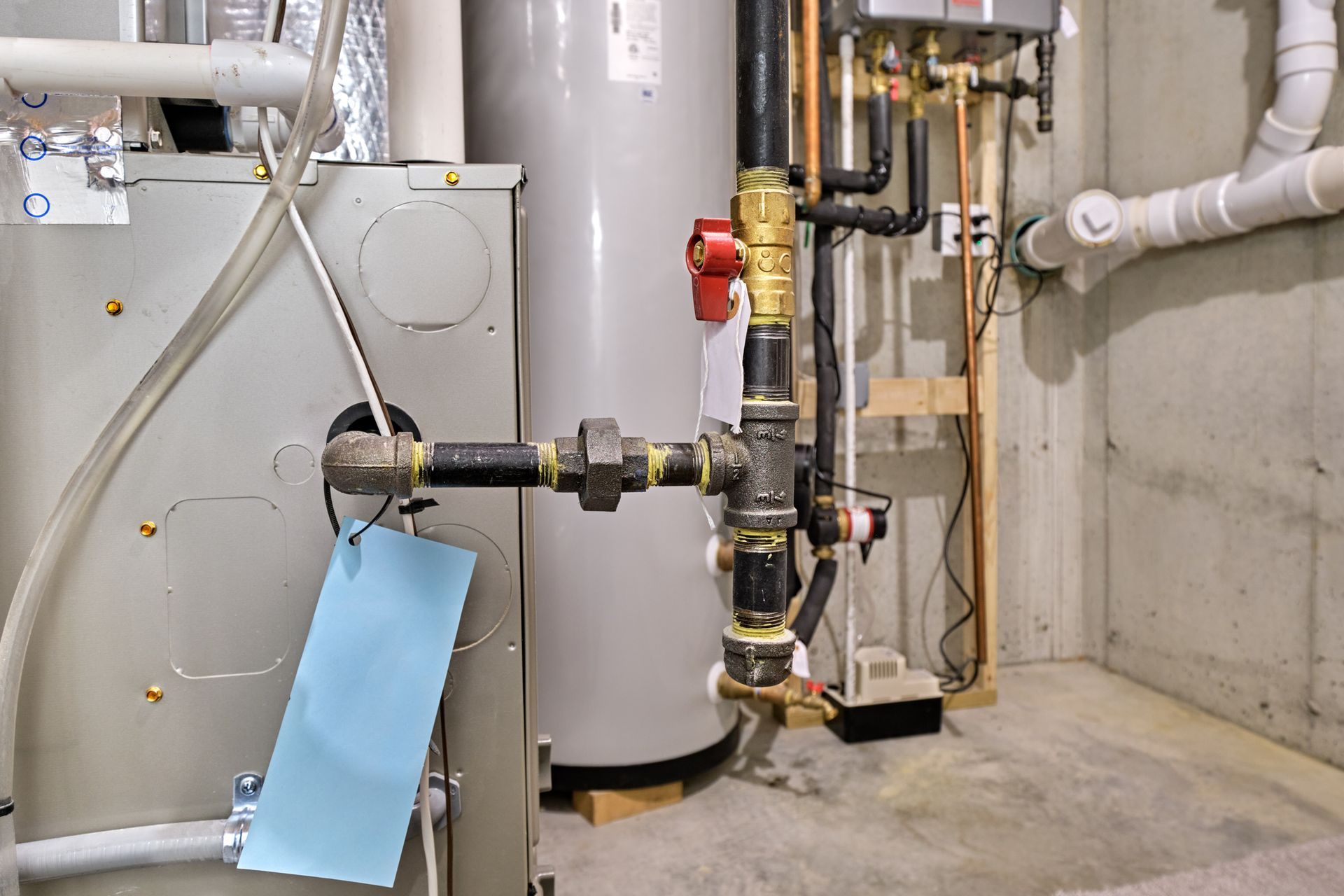 Furnace gas line in basement mechanical room.