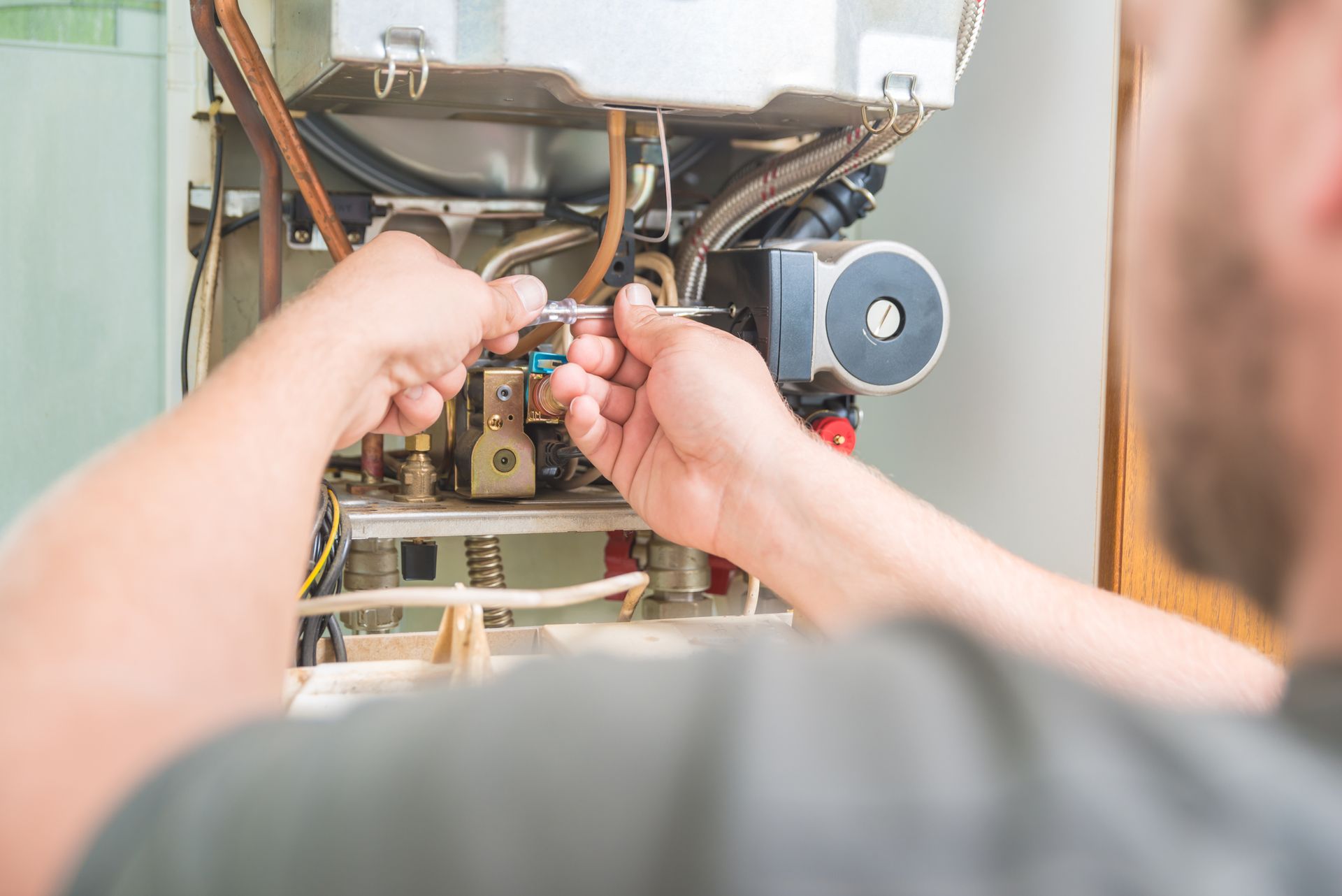 A technician is installing a gas furnace.