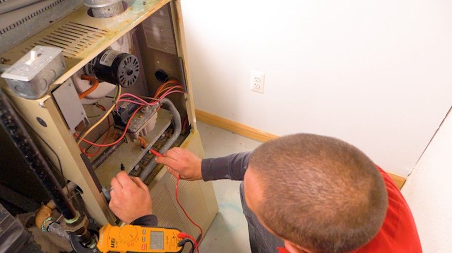 Technician testing furnace system. Technician testing furnace system.