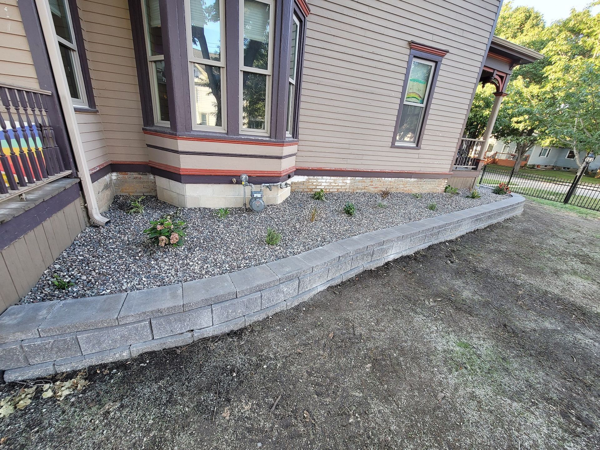 A house with a gravel driveway in front of it.