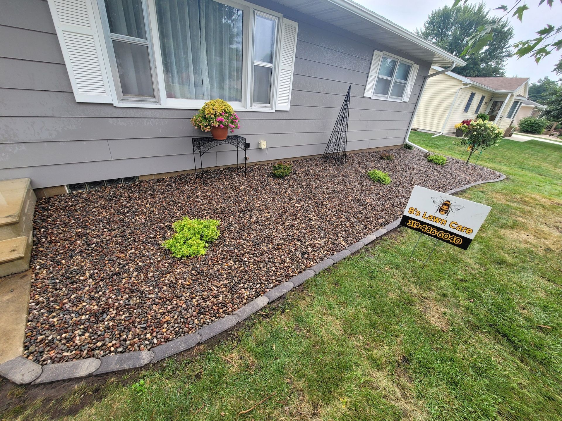 A house with a lot of gravel in front of it.