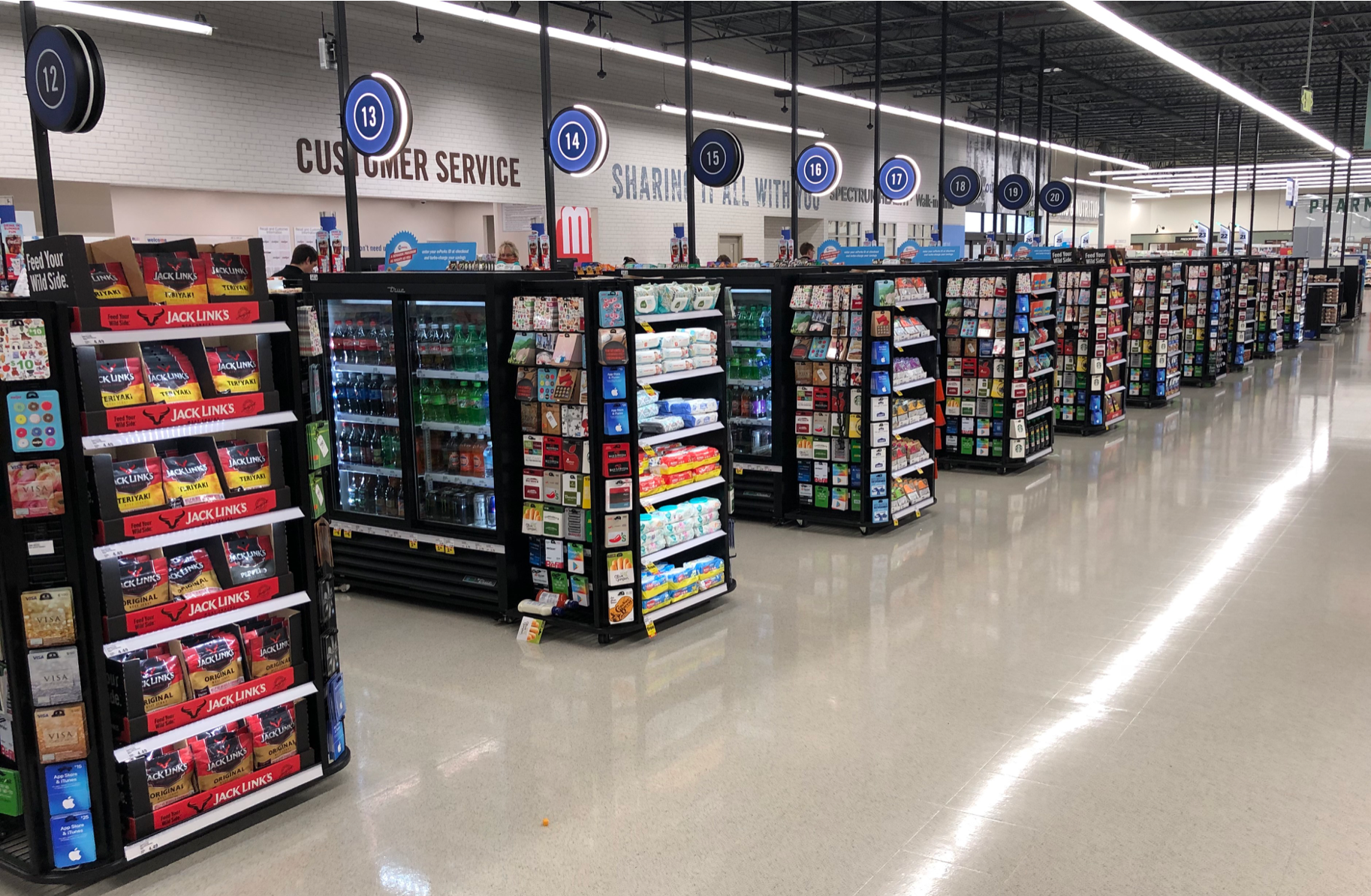 A grocery store filled with lots of shelves and coolers.