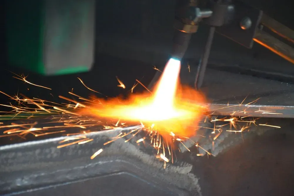 A Metalworker Uses a Torch, Creating Sparks — Rod's Engineering & Lifetime Trailers in Bli Bli, QLD