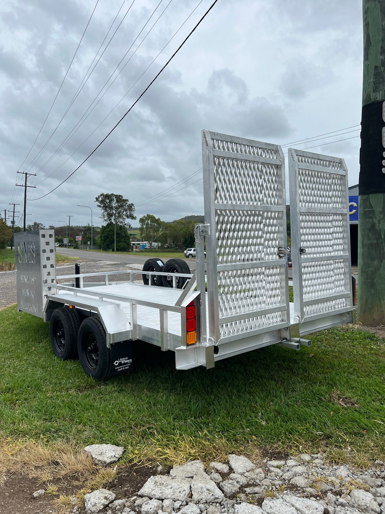 White Truck With a Camper on a Grassy Field — Rod's Engineering & Lifetime Trailers in Bli Bli, QLD