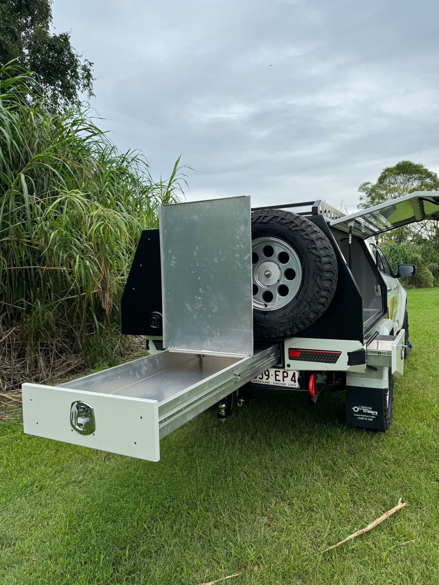 White Pickup Truck With a Diamond-plated Aluminum Canopy — Rod's Engineering & Lifetime Trailers in Bli Bli, QLD