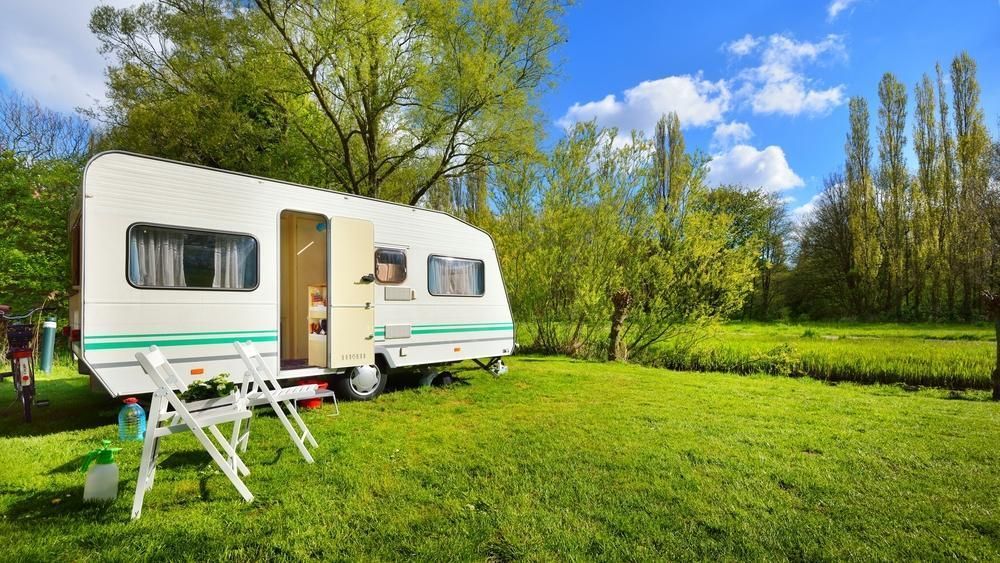 White Camper Parked on a Grassy Field — Rod's Engineering & Lifetime Trailers in Bli Bli, QLD