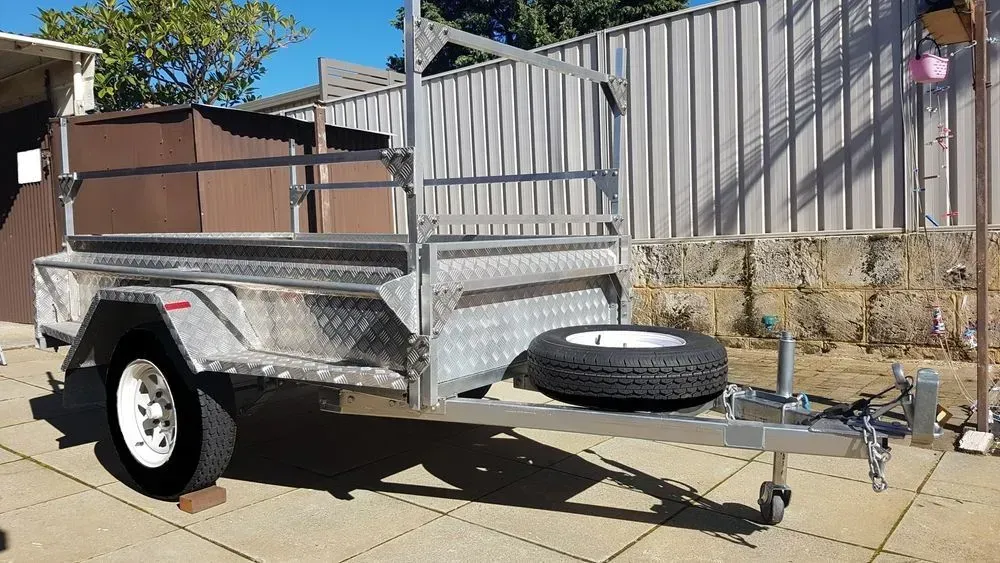 A Silver Utility Trailer With a Brown Box — Rod's Engineering & Lifetime Trailers in Bli Bli, QLD
