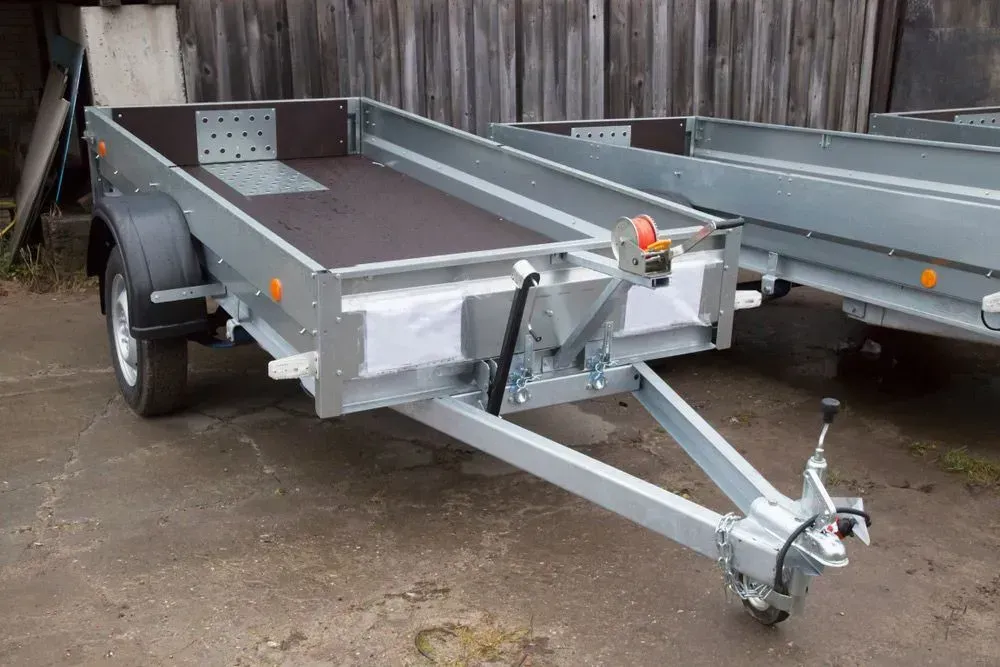 Gray Utility Trailer With a Black Deck, Set on a Concrete Surface — Rod's Engineering & Lifetime Trailers in Bli Bli, QLD