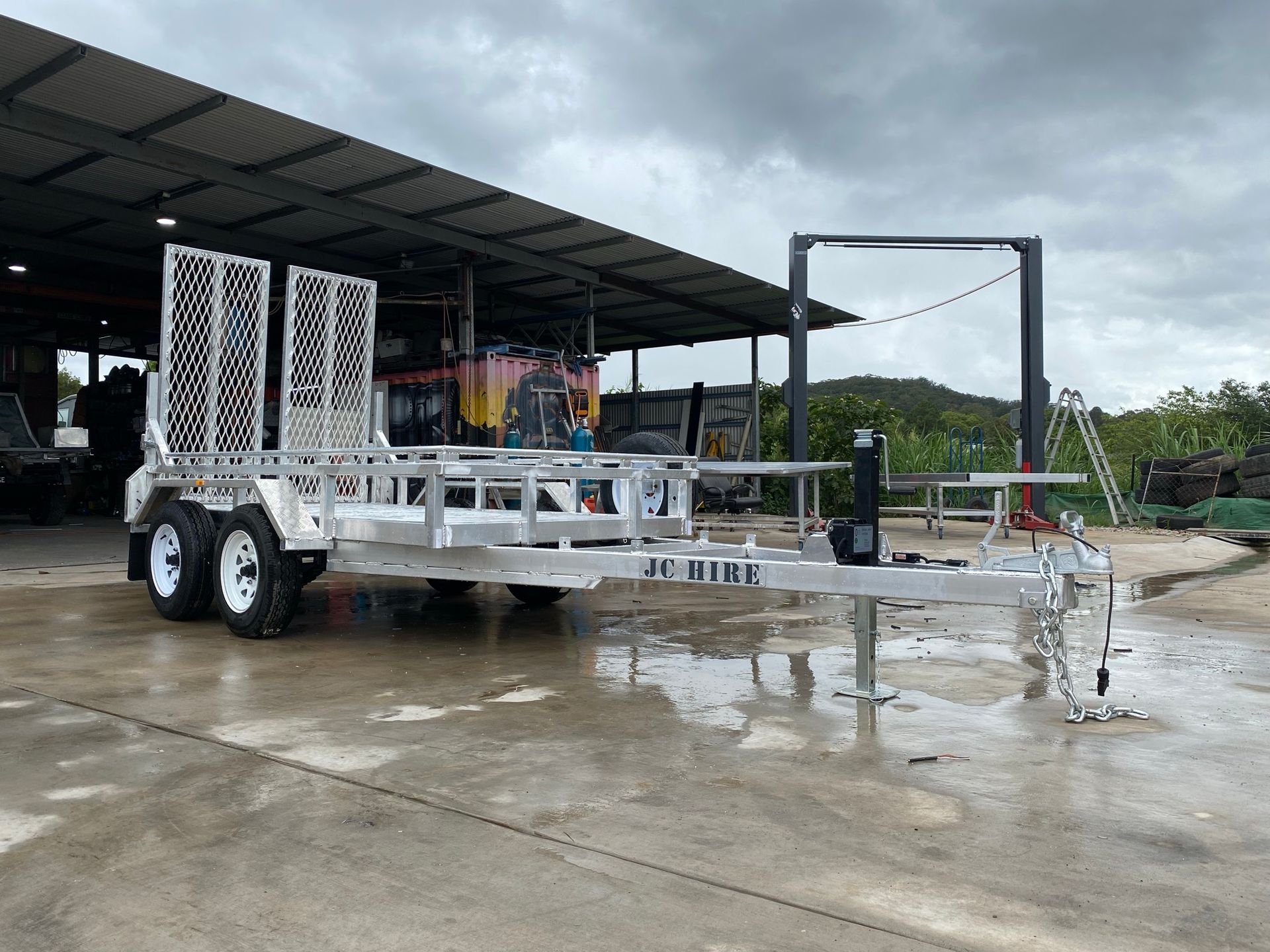 Car Trailer With a Metal Deck, and Multiple Wheels — Rod's Engineering & Lifetime Trailers in Bli Bli, QLD