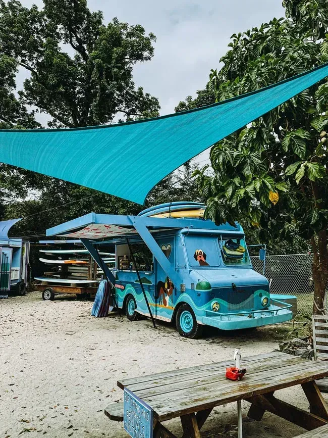 Blue Food Truck With Surfboard Rack, Under Turquoise Shade — Rod's Engineering & Lifetime Trailers in Bli Bli, QLD