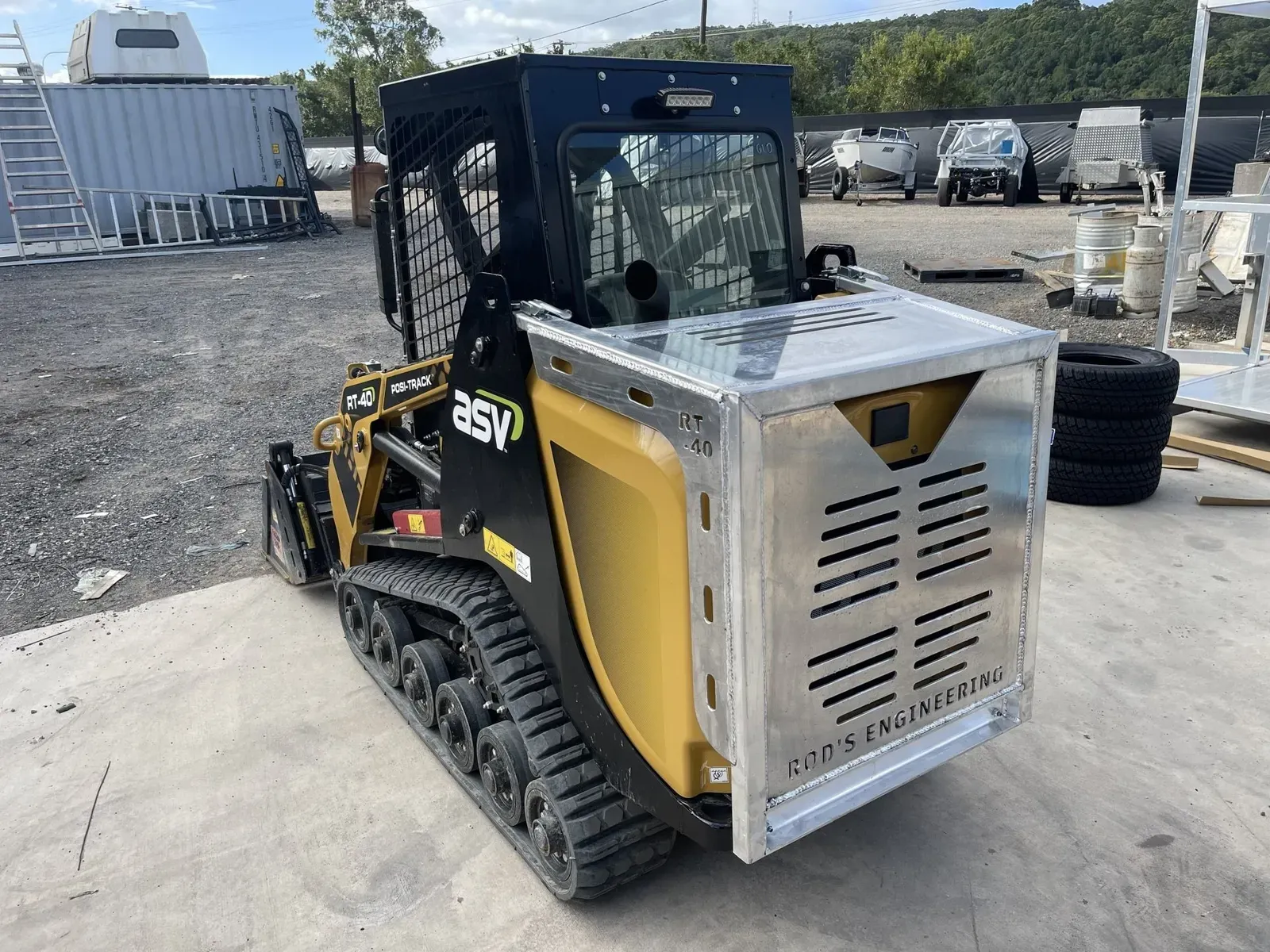 Yellow and Black Track Loader With a Metal Guard — Rod's Engineering & Lifetime Trailers in Bli Bli, QLD