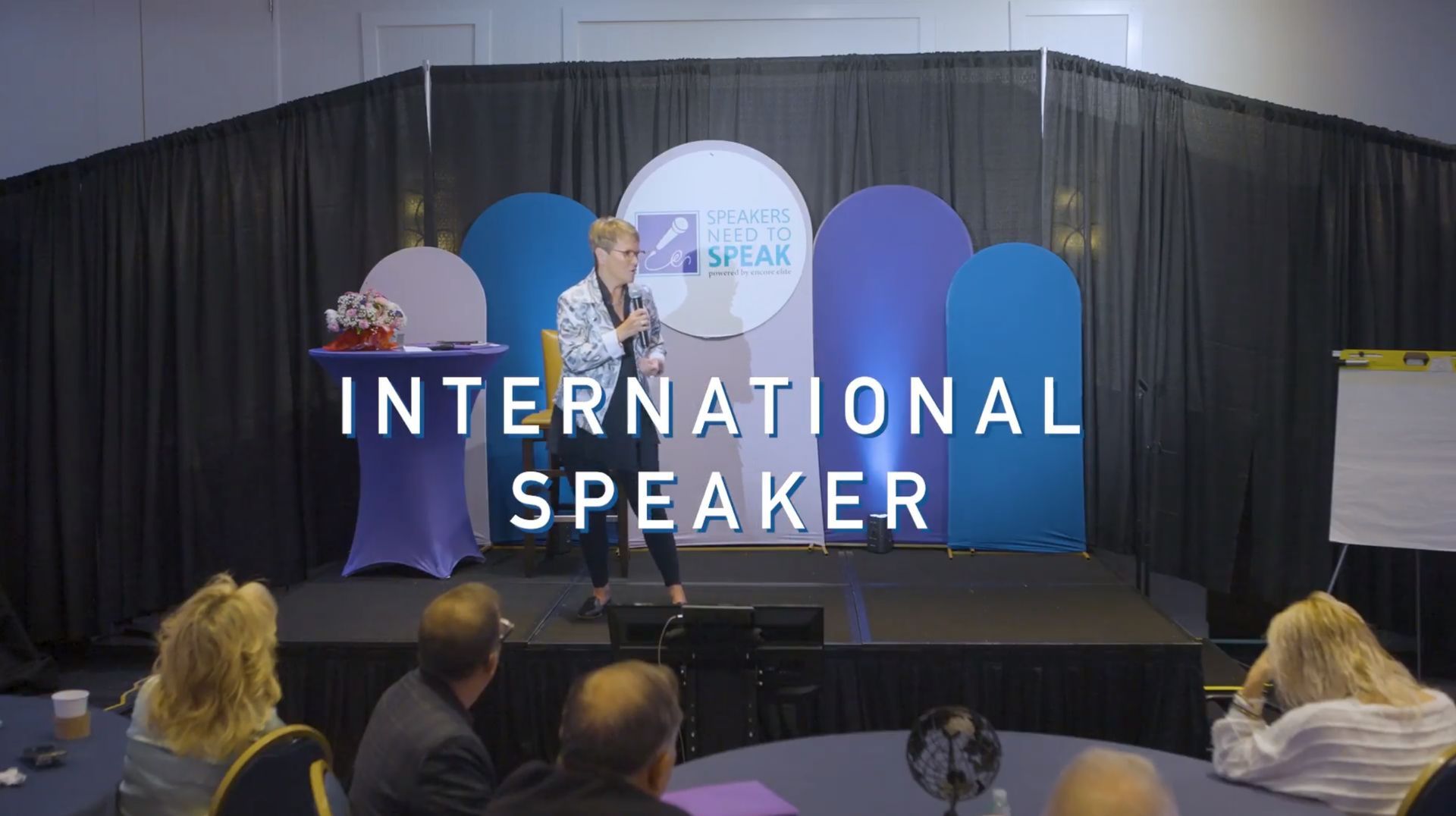 Woman speaking on stage,