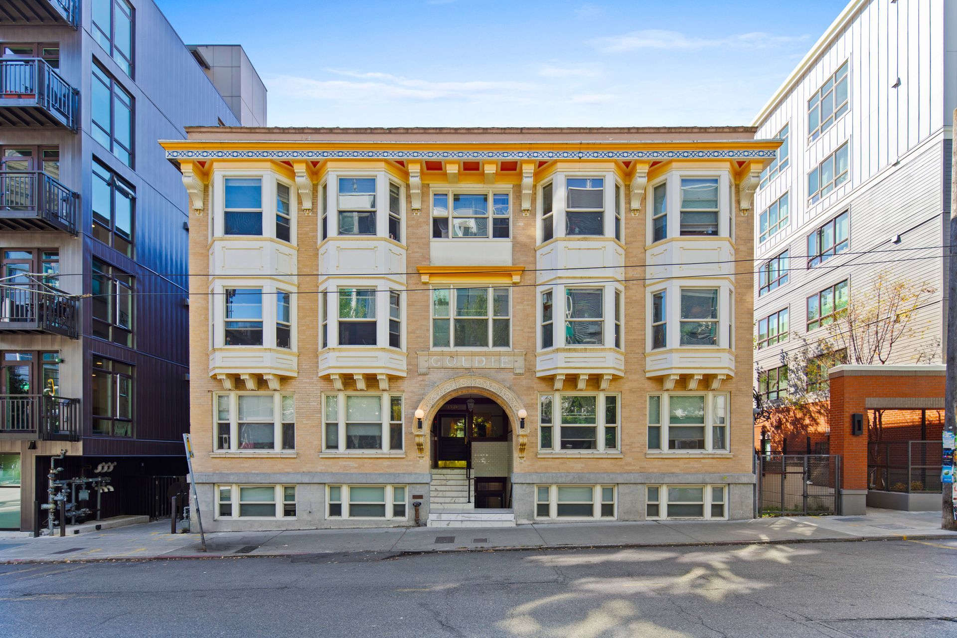A tall brick building with a fire escape on the side of it