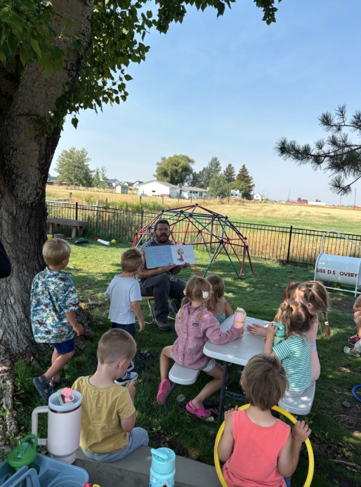 Montessori guide and students during outdoor activities
