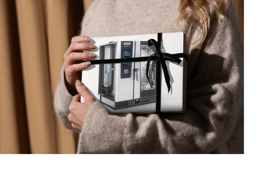 Une femme tient une boîte avec l'image d'une machine dessus.