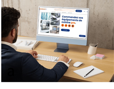 Un homme est assis à un bureau en train d'utiliser un ordinateur.