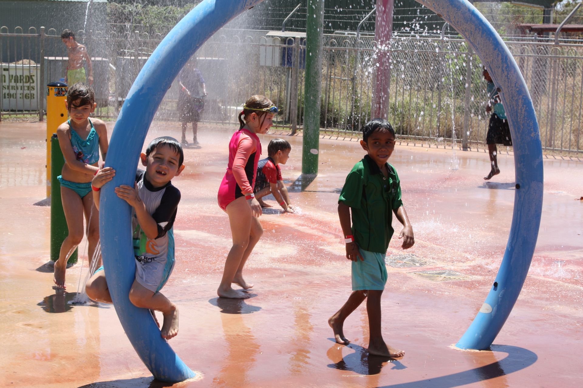 A group of children are playing in a water park