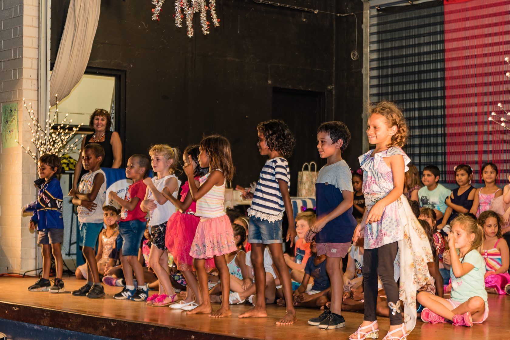 A group of children are standing on a stage.
