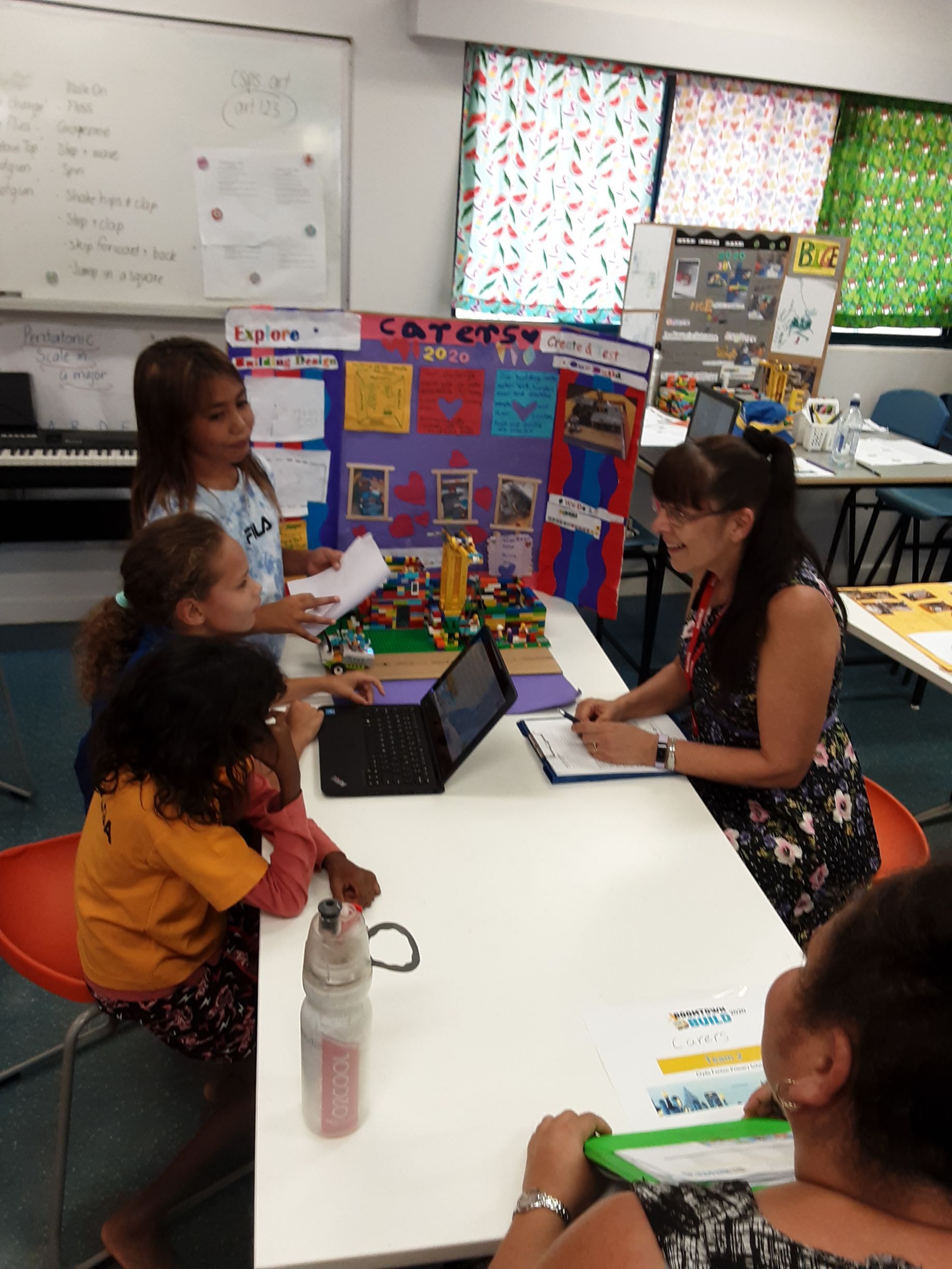 A group of people are sitting around a table with a sign that says safety