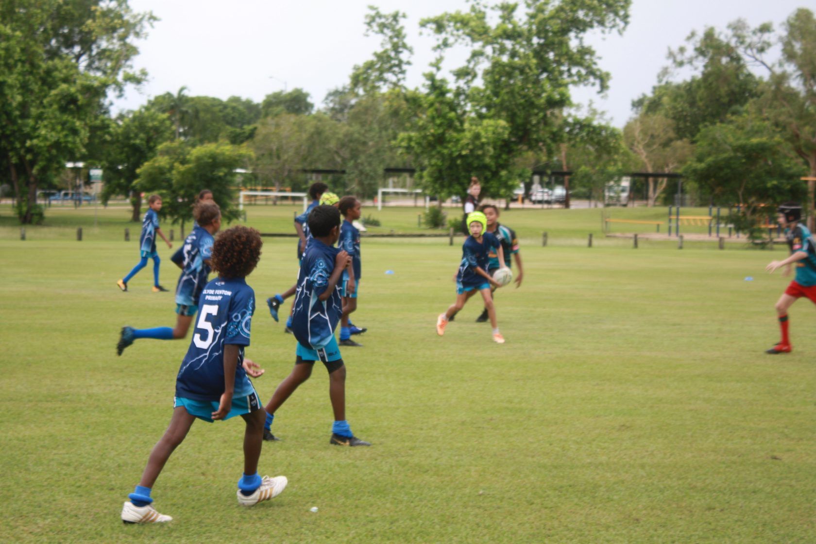 A group of young boys are playing soccer on a field.