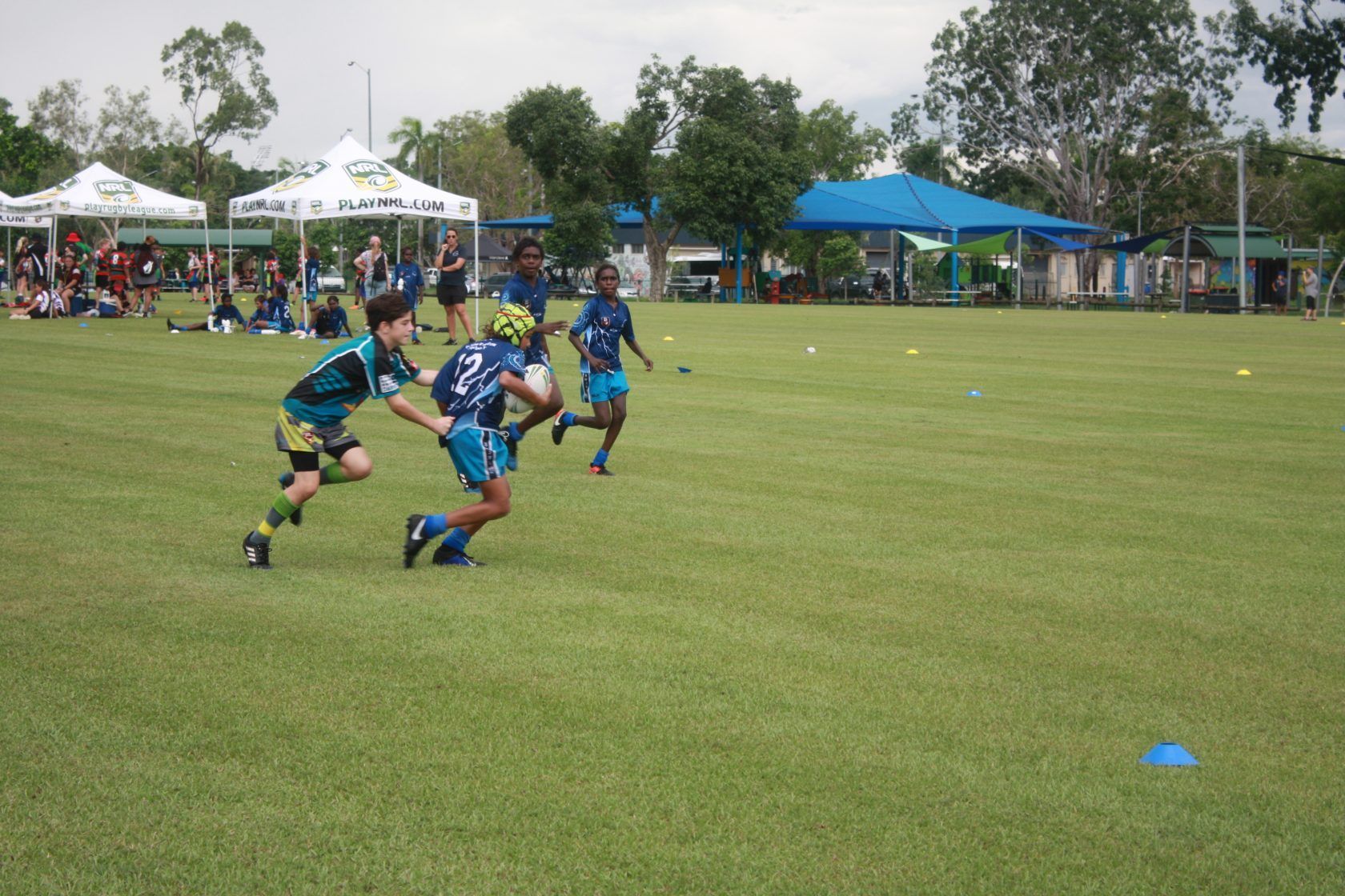 A group of kids are playing soccer on a field
