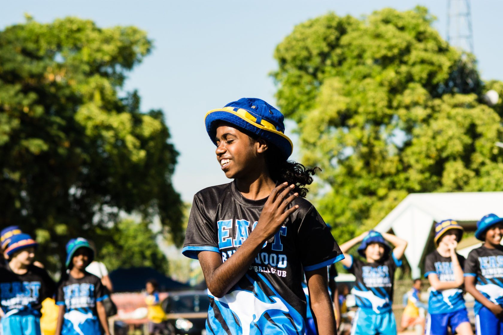 A group of children are dancing in a park.