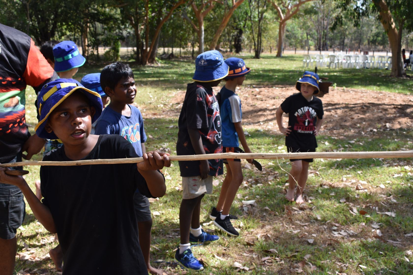 A group of children are playing a game in a park.