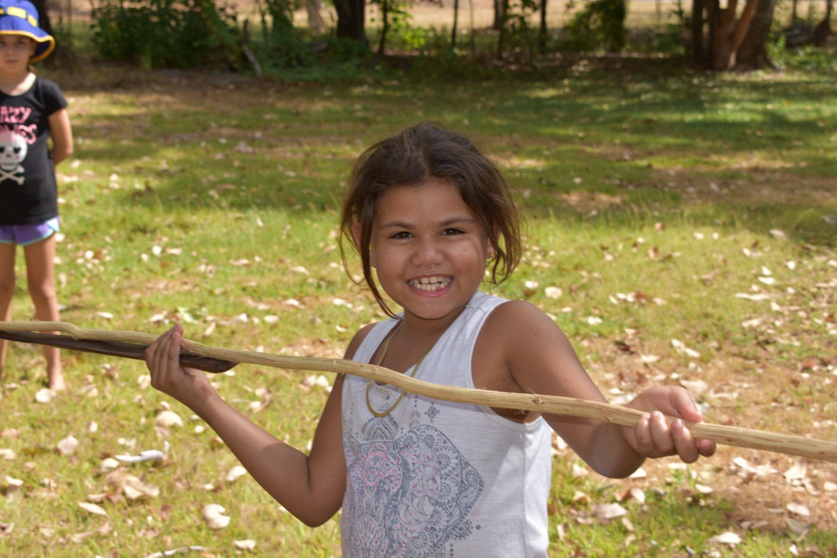 A student holding a stick outside