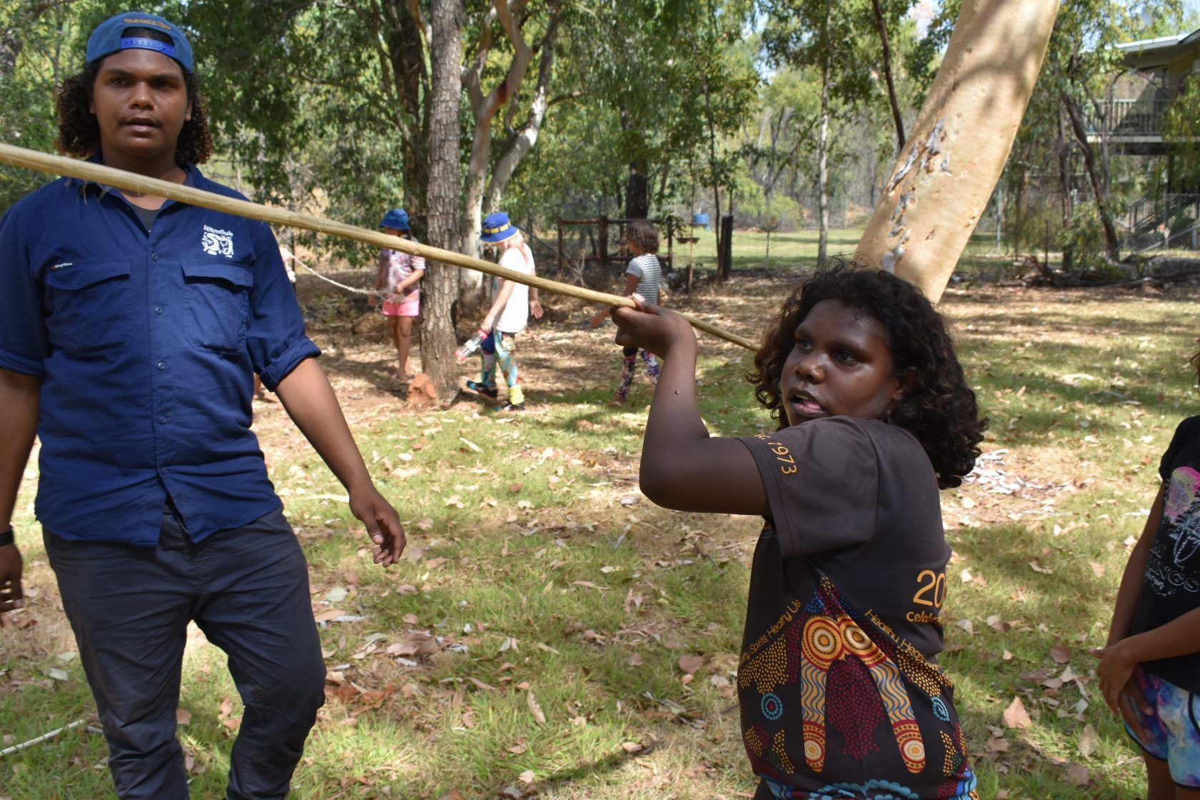 A group of people are playing a game in a park.
