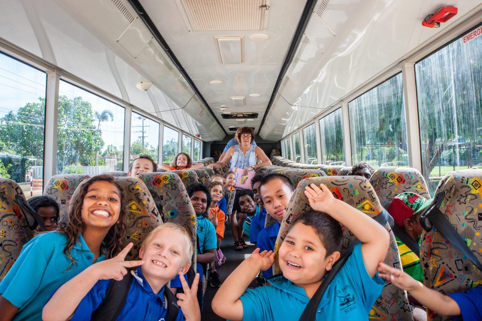A group of children are sitting on a bus.