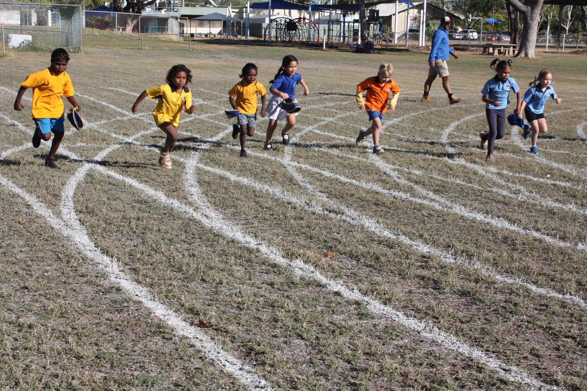 A group of children are running on a track.