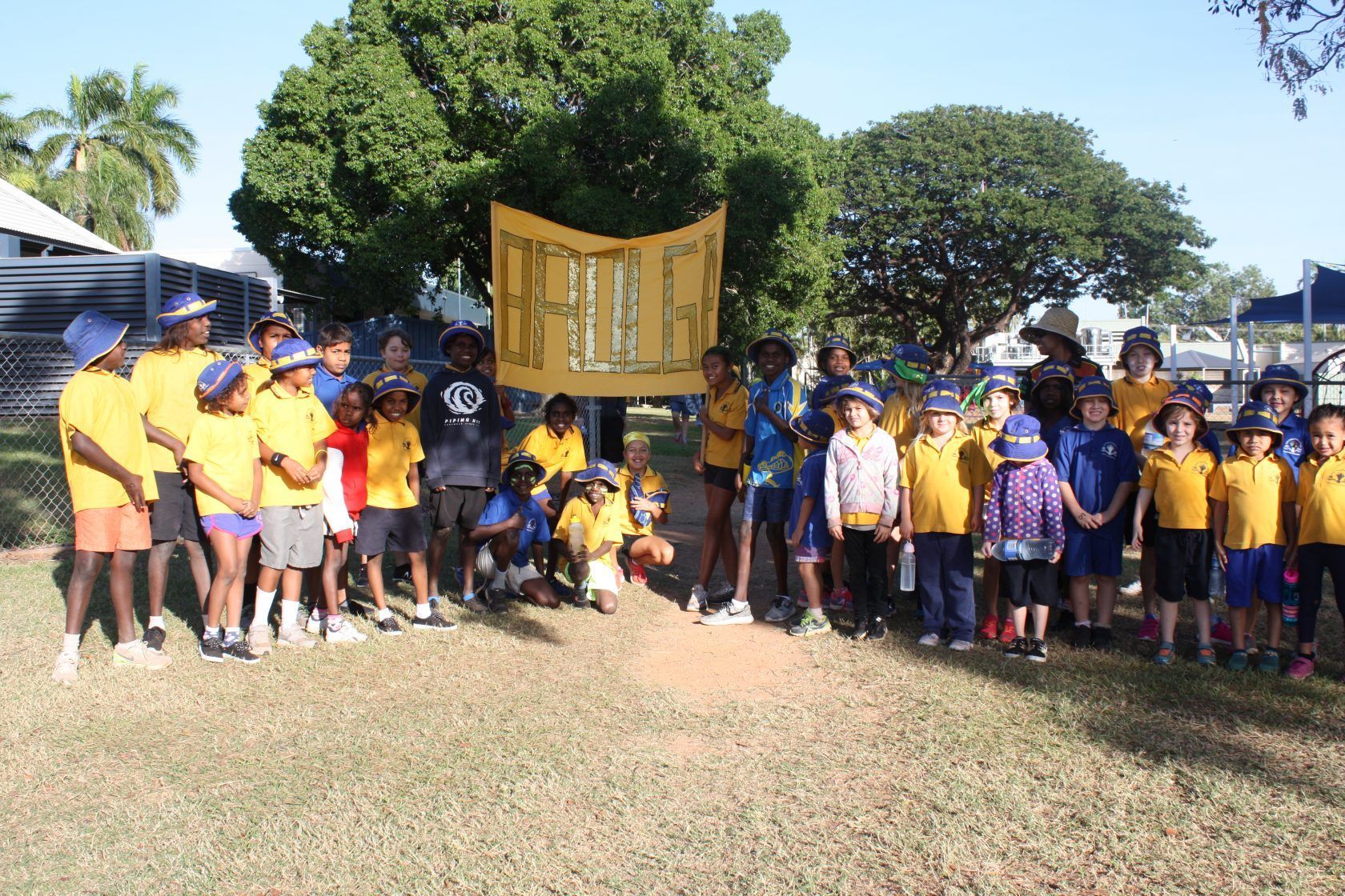 A group of children standing in a field holding a sign that says justice