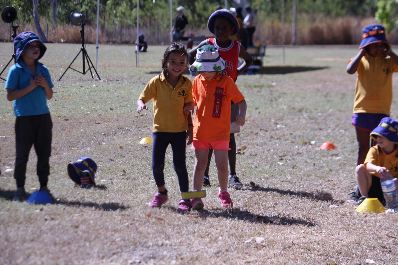 A group of children are playing a game in a field.