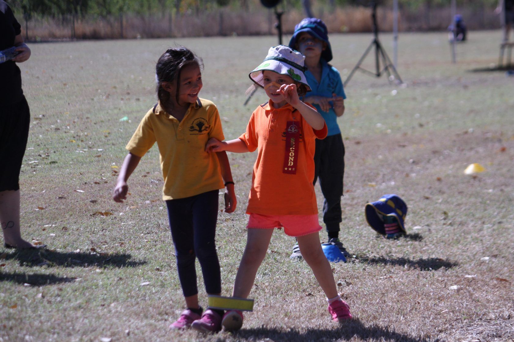 A group of young girls are playing a game in a field.