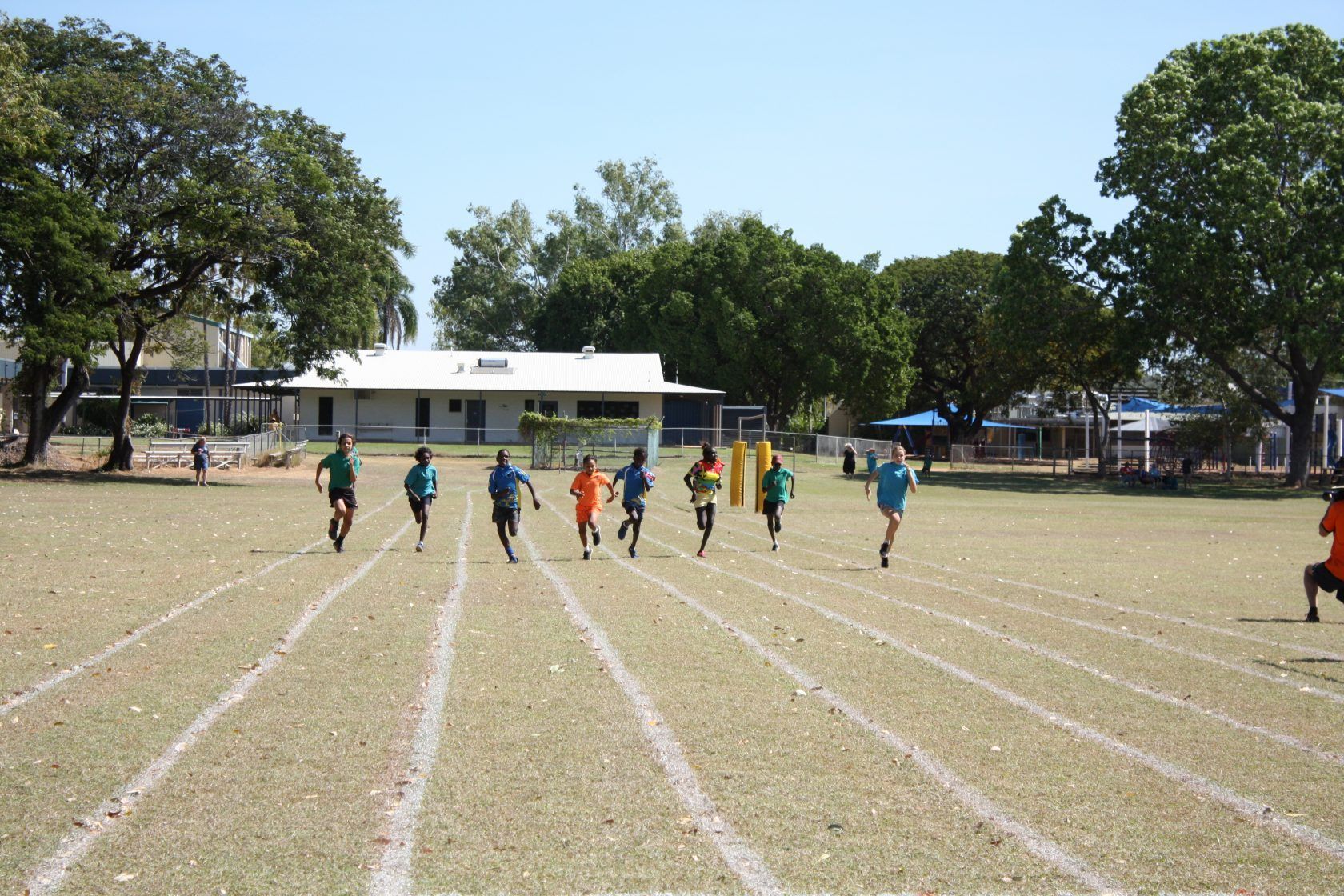 A group of children are running on a track