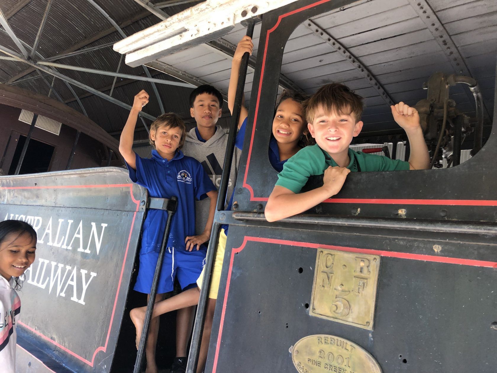 A group of children are riding on the back of a train.