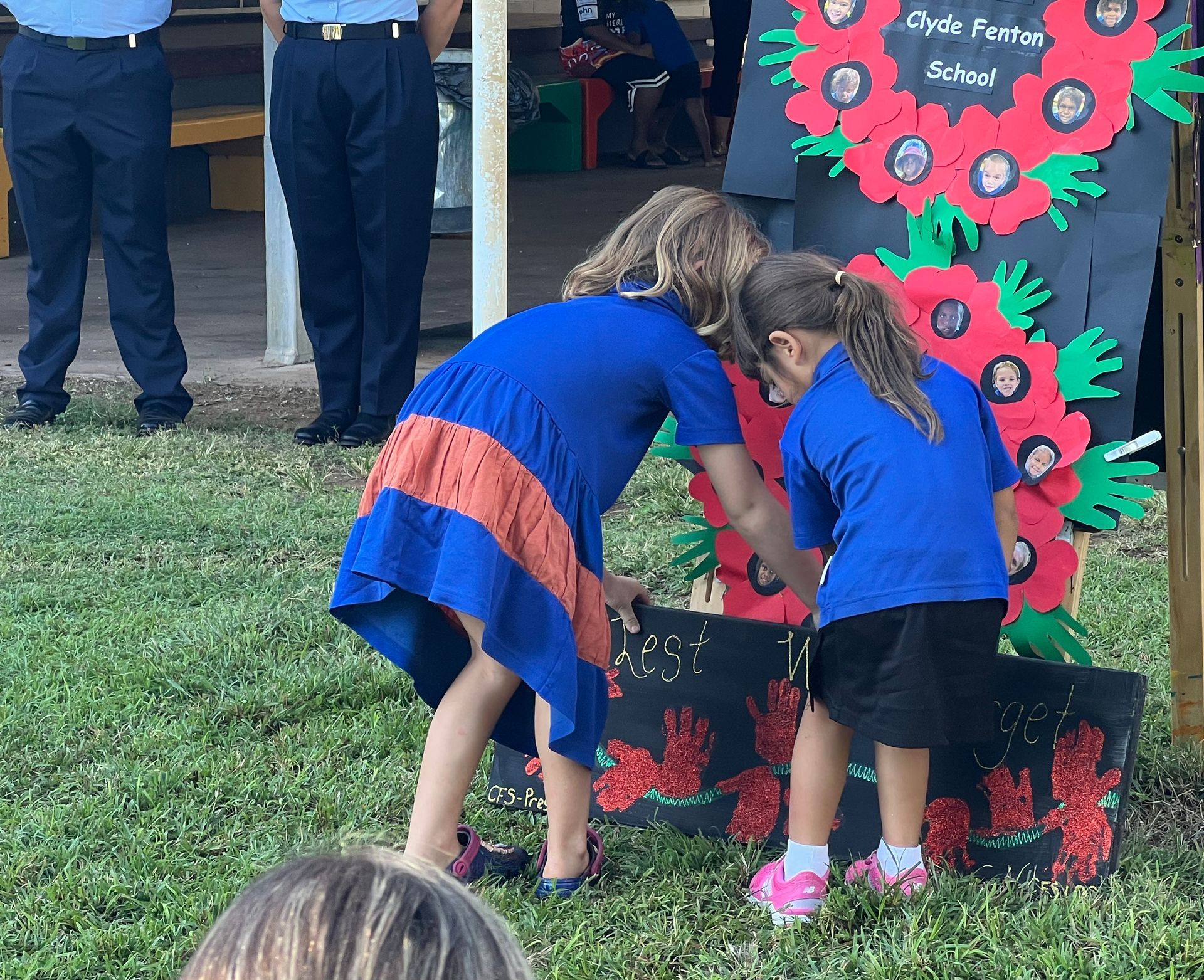 Two little girls standing in front of a sign that says cycle to school