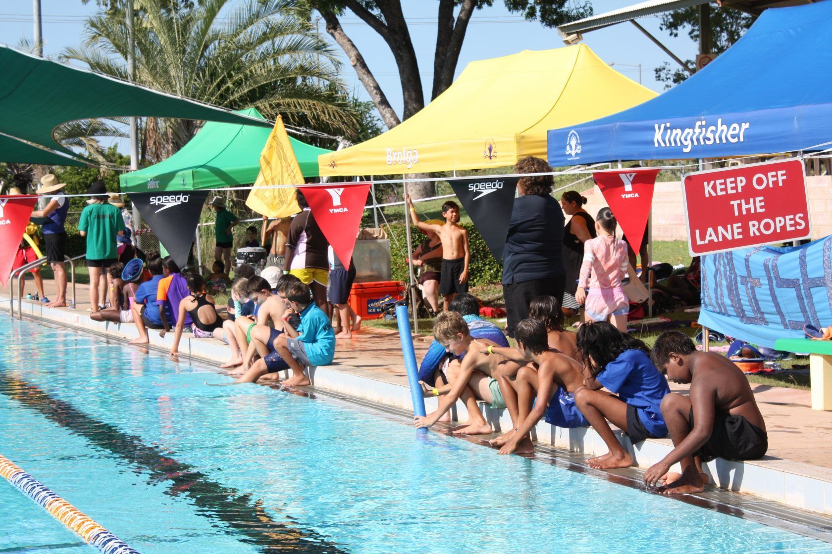A swimming pool with a sign that says keep off the lane ropes