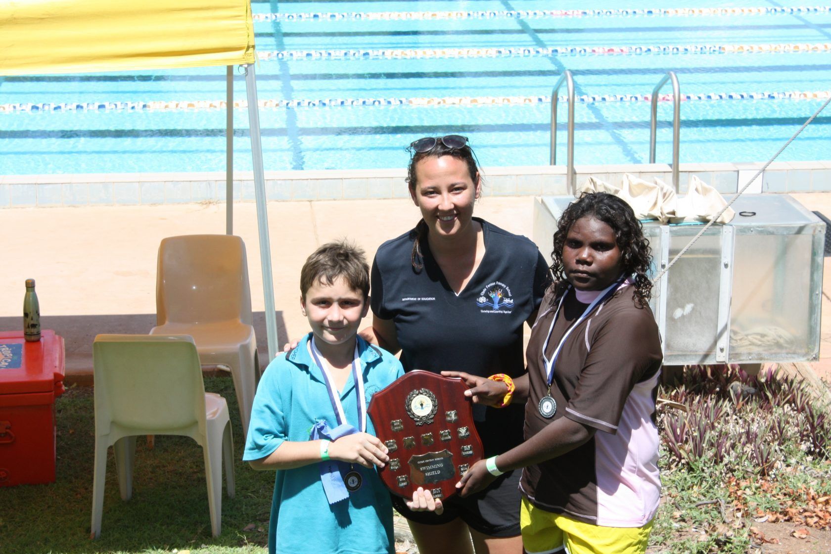 A group of people standing next to each other holding a plaque