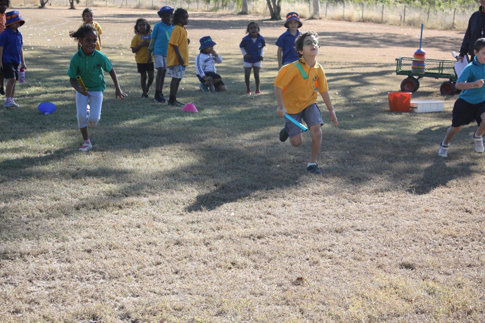 A group of children are running in a field