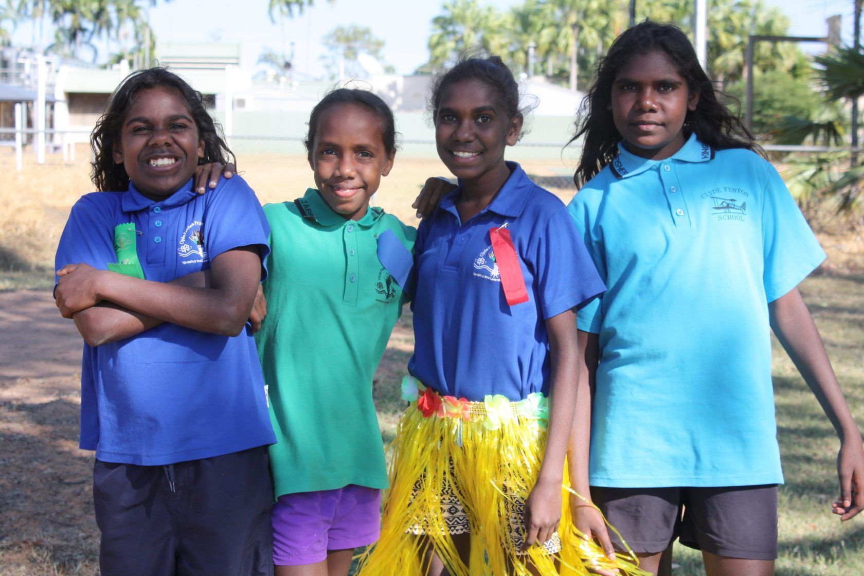 A group of young girls are posing for a picture together.
