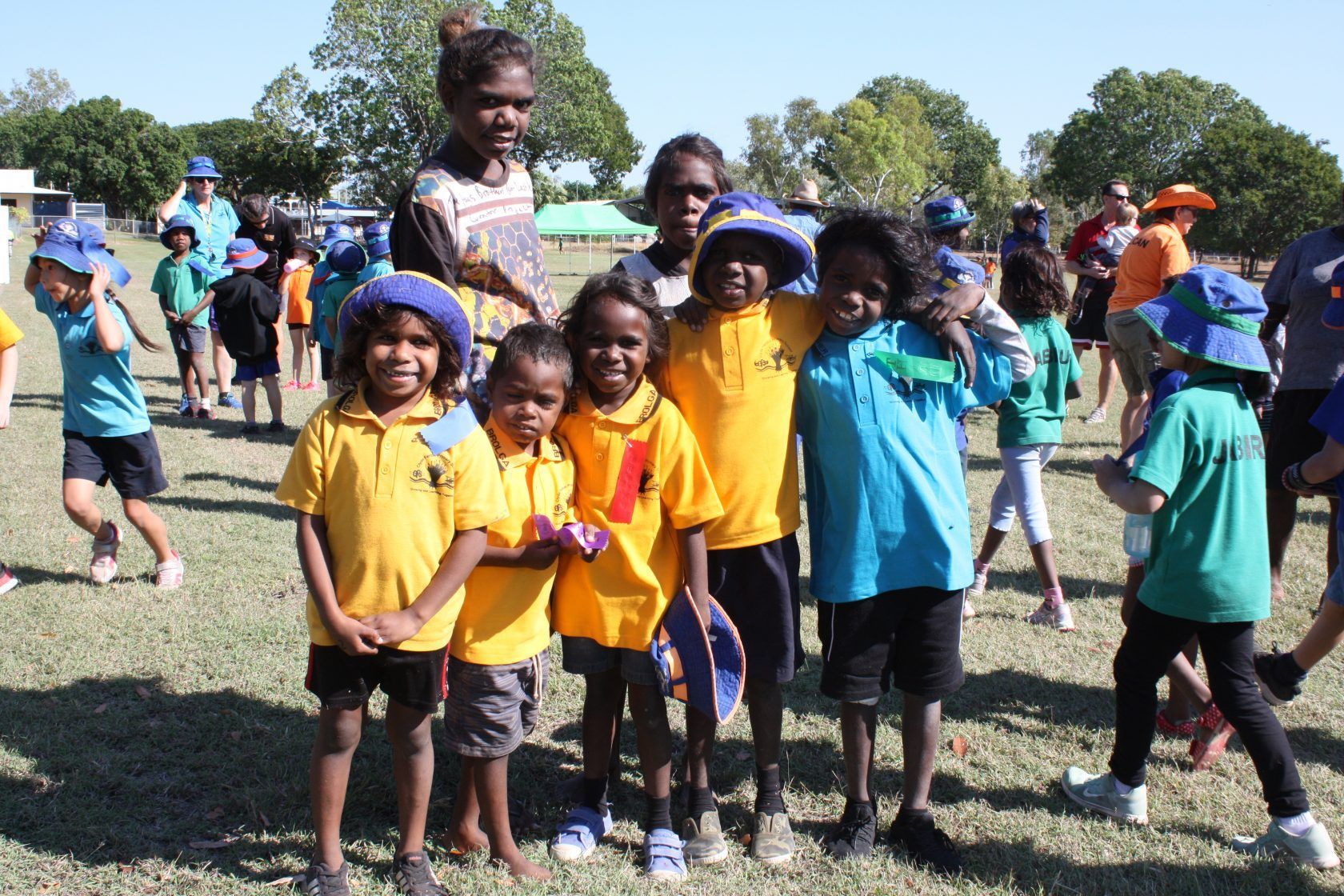 A group of children are posing for a picture in a field