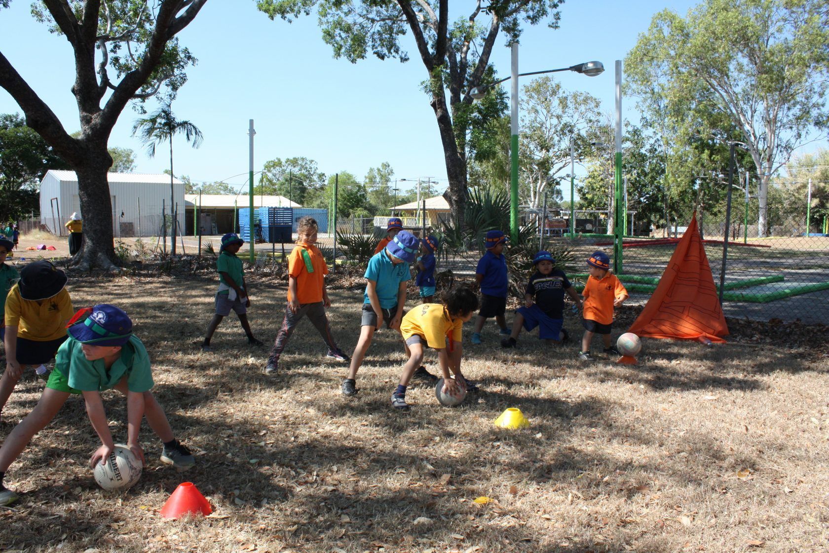 A group of children are playing soccer in a park