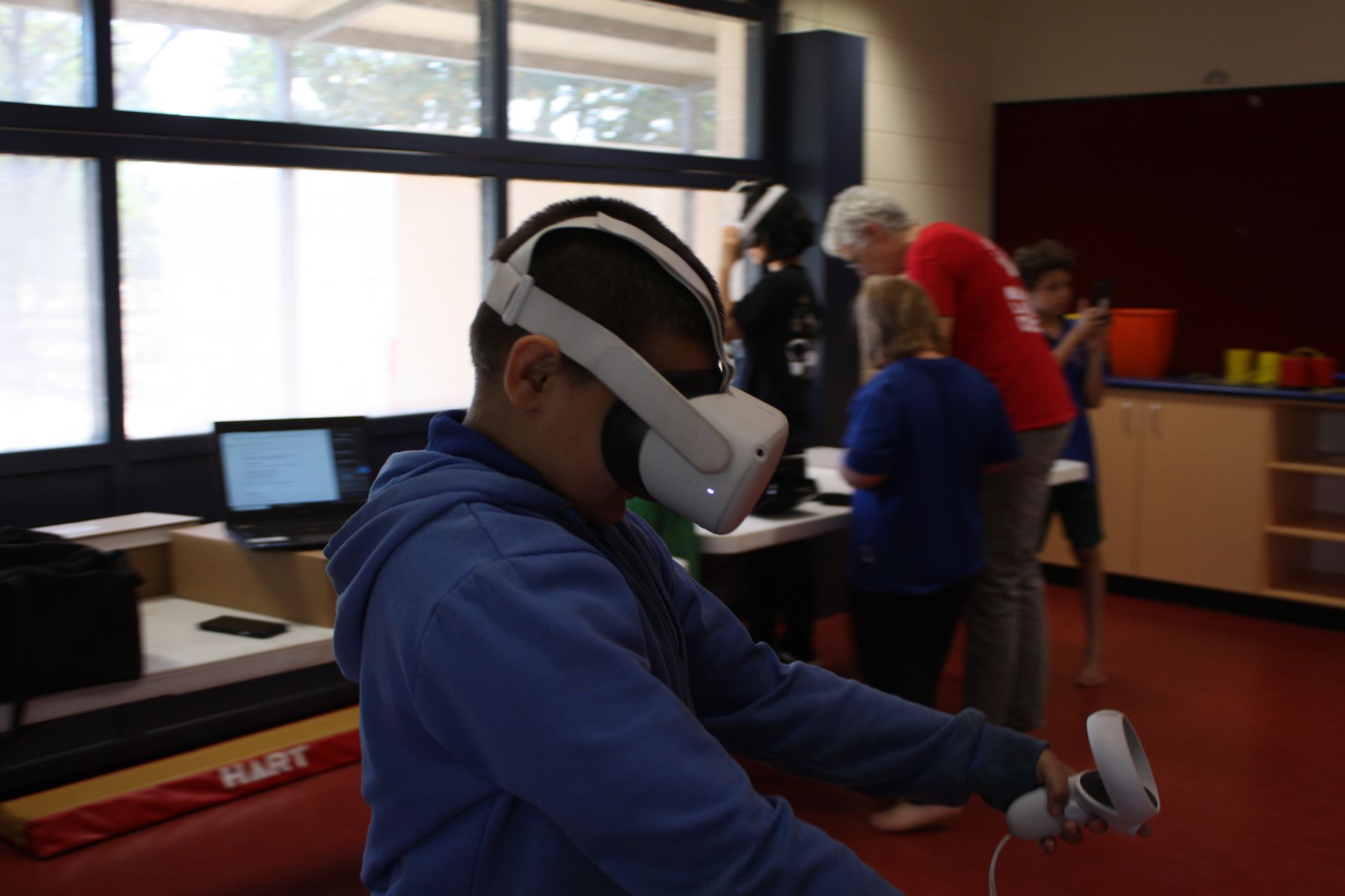 A boy wearing a virtual reality headset in a room