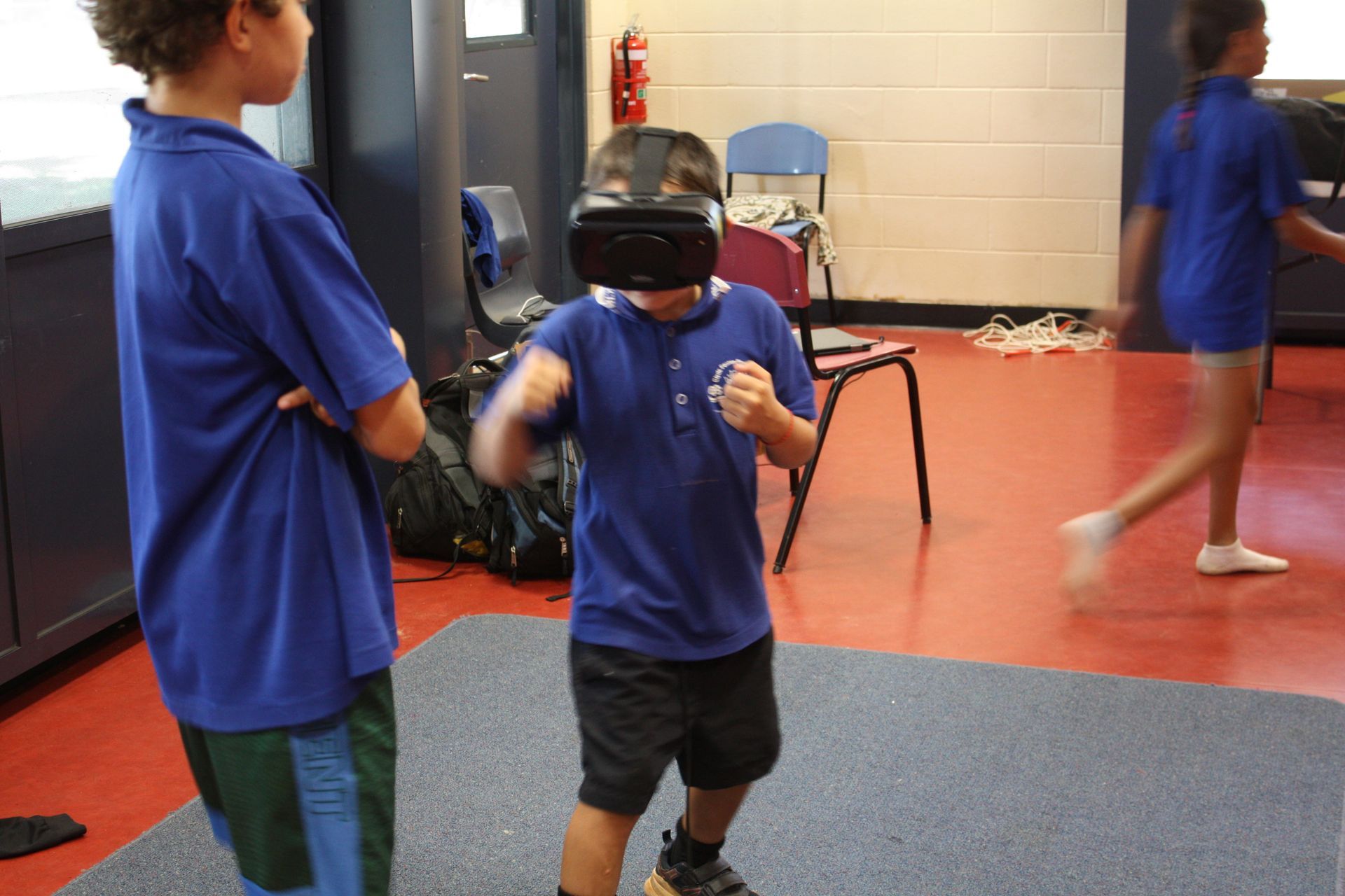 A boy wearing a virtual reality headset in a room