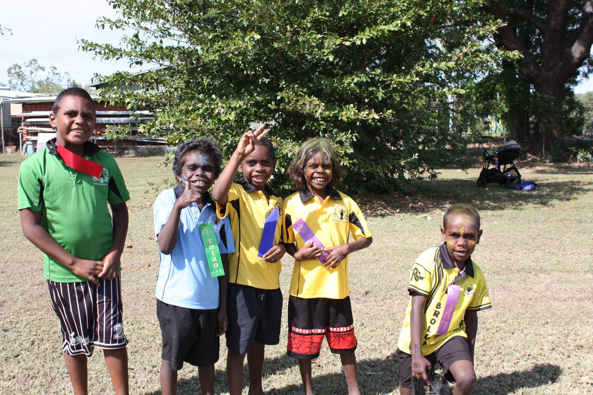 A group of children are posing for a picture in a field