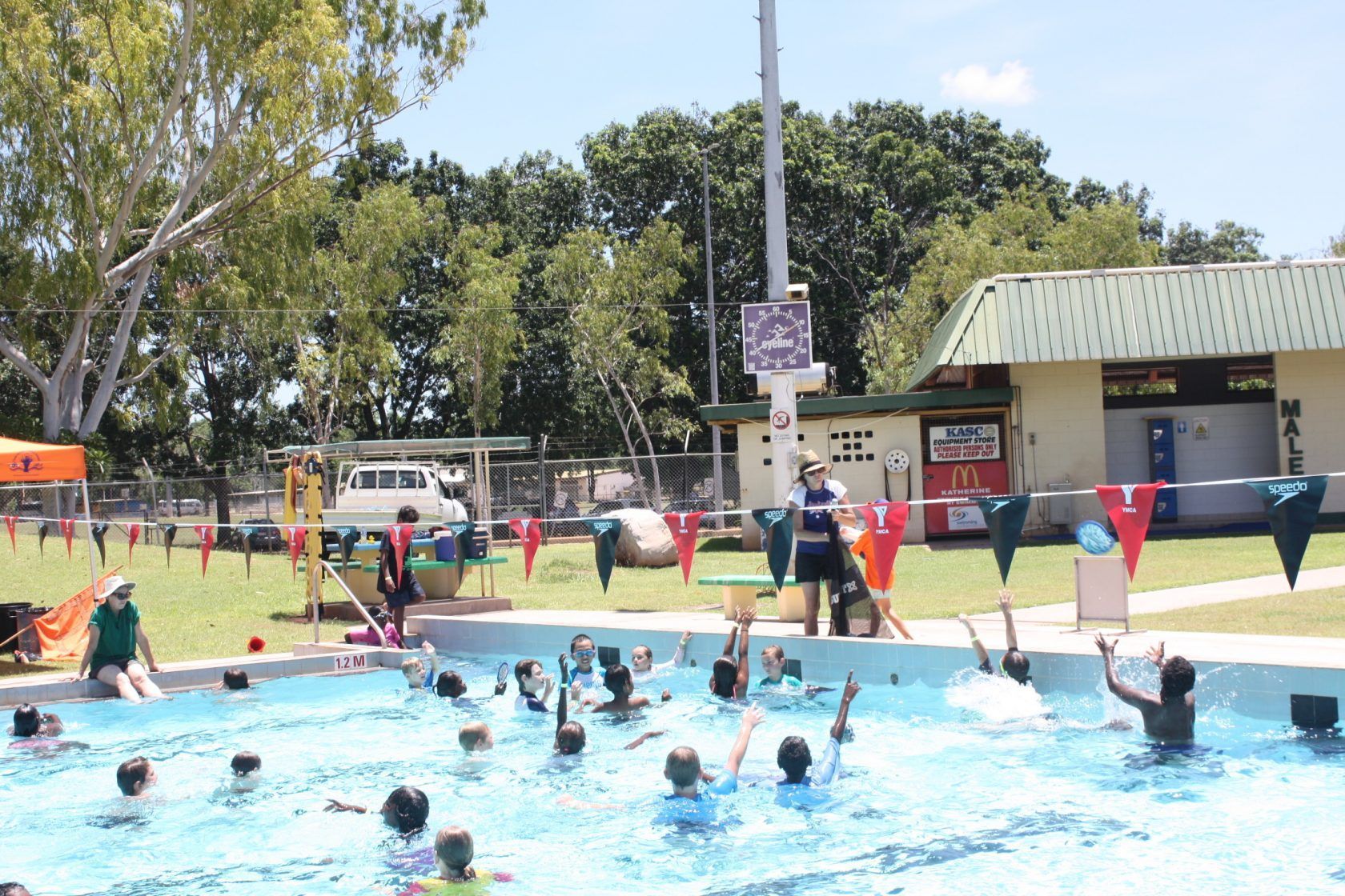 A group of people are swimming in a swimming pool